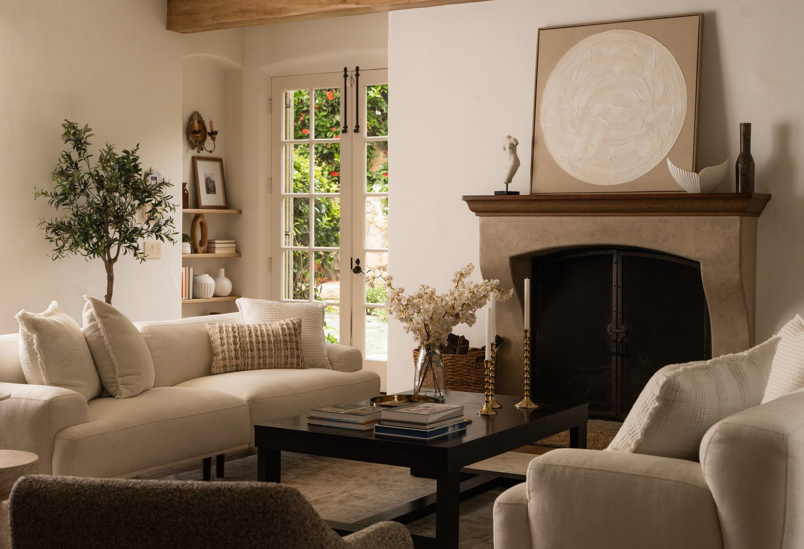 Living room with a fireplace and arched openings, designed by S & S Interiors