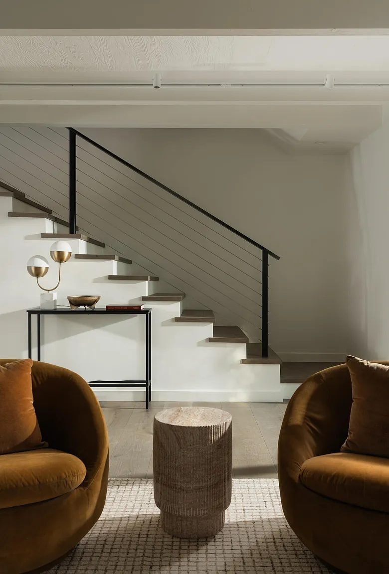 Staircase with gold accent chairs